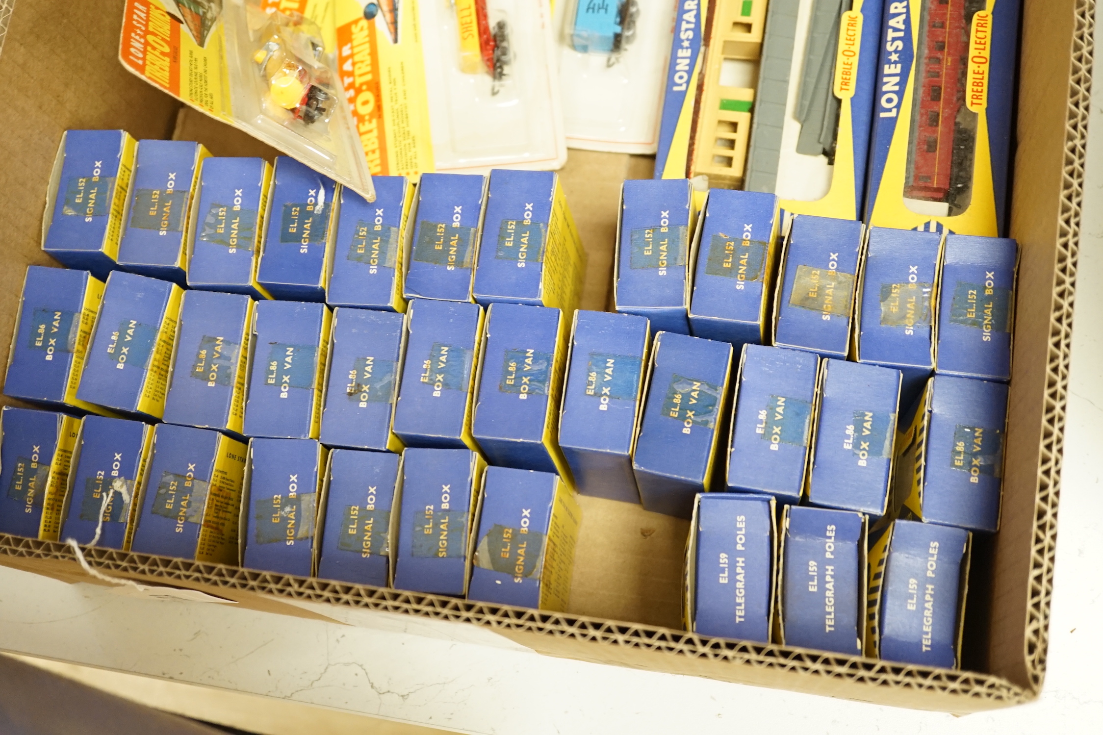Sixty-two boxed items of Lone Star 000 gauge model railway including; a tunnel, Brake End Coaches, bogie wagons, station platforms, platform extensions, signal boxes, box vans, and telegraph poles